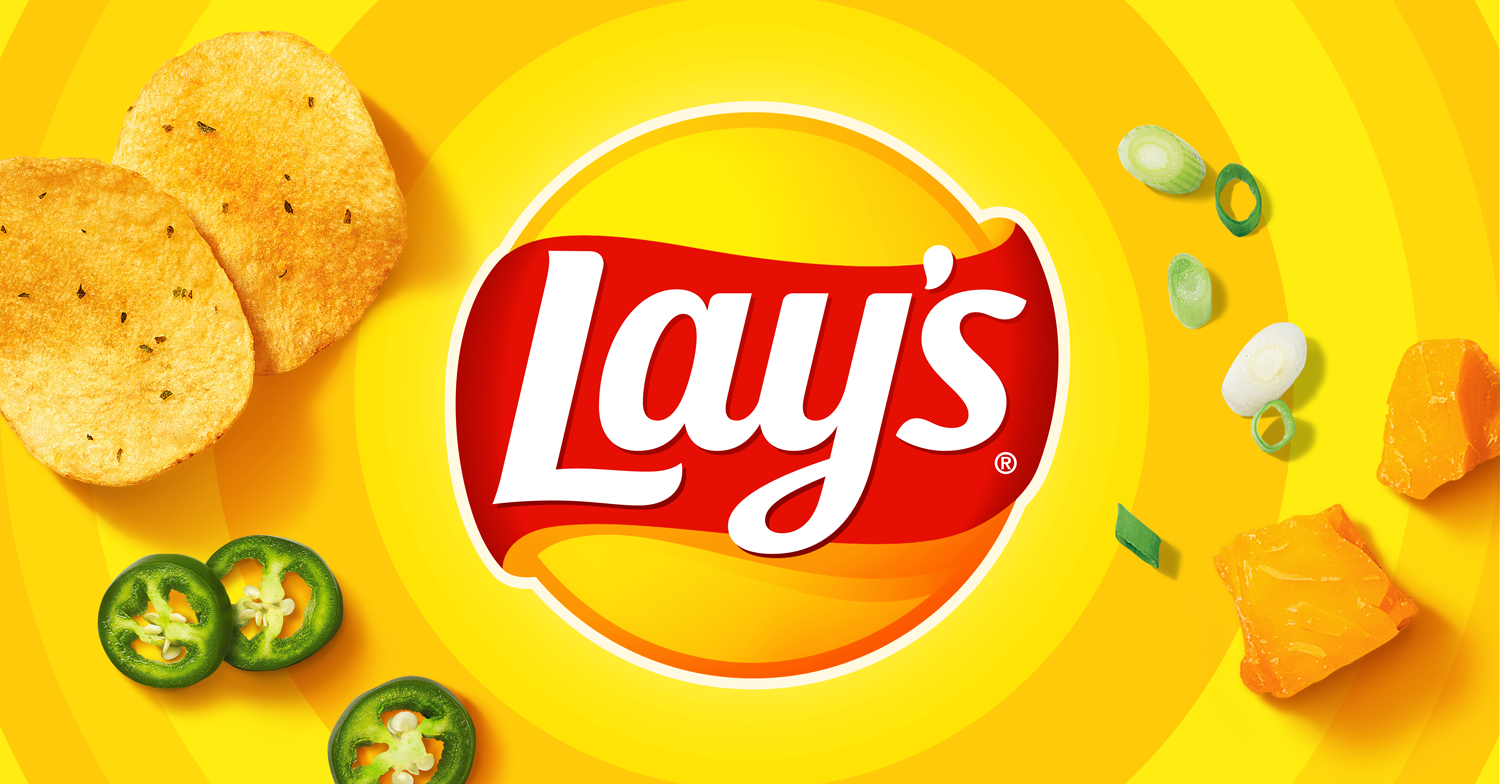 Lay's potato chips bag surrounded by potato chips, green jalapeño slices, green onion slices, and pieces of cheddar cheese on a yellow background.